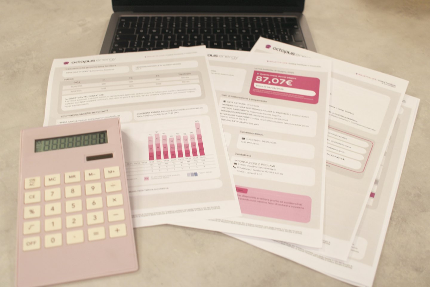 Octopus energy bills spread on a desk with a calculator.